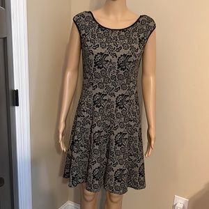 Scoop-neck, knit mini dress. Black with lace-look.